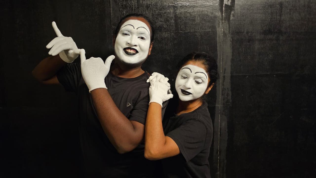Two mime performers in white masks during a Streets of Bangalore performance.